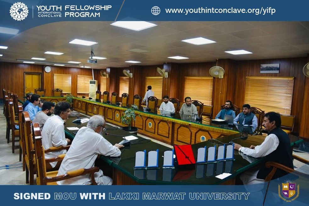 Group of individuals seated around a conference table engaged in a meeting. YIC President, VC, and Lakki Marwat Fellows discussing empowerment and growth opportunities.