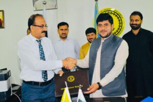 YIC President shaking hands with Campus Director of Iqra National University Swat