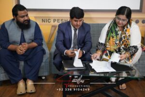 A photo of Engr. Umar Farooq Gul and Ms. Qurat Ul Ain during the MOU signing ceremony between Youth International Conclave (YIC) and AiN Consulting Co.