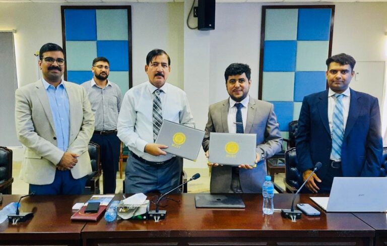 Representatives from YIC and MUST Mirpur signing the MOU for Youth International Fellowship Program in AJK.